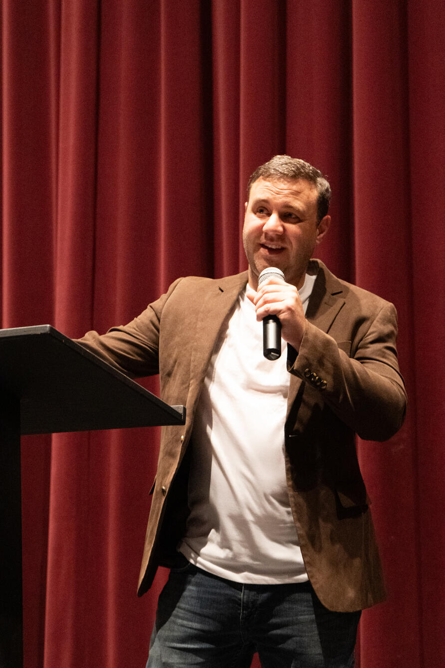 Matt Gromlich speaking in an auditorium